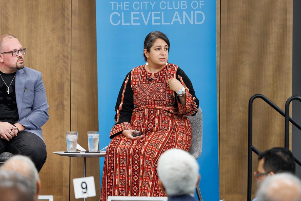 Shereen Naser, PhD points to herself while sharing her experiences at The City Club of Cleveland for an invited talk