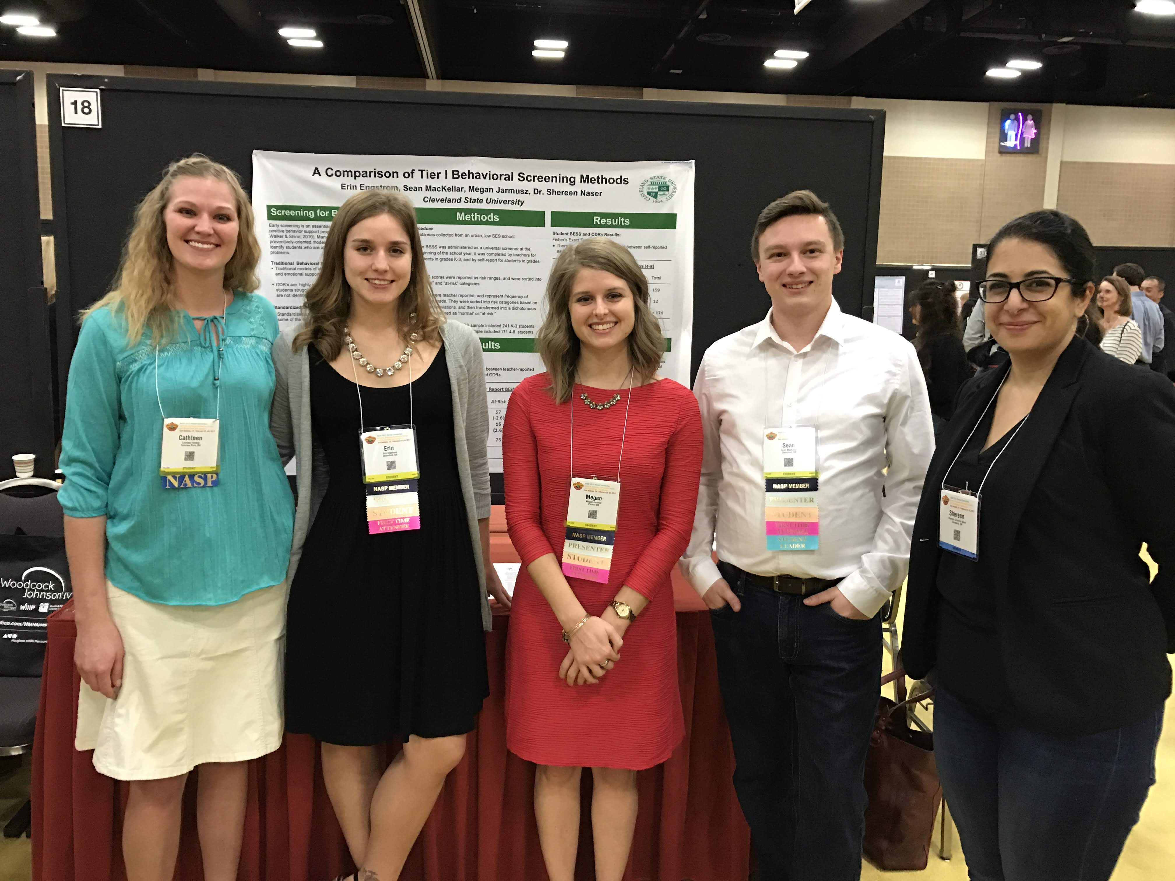 Dr. Shereen Naser and 4 students stand by a research poster on A Comparison of Tier I Behavioral Screening Methods by Erin Engstrom, Sean MacKellar, Megan Jarmusz, and Dr. Shereen Naser