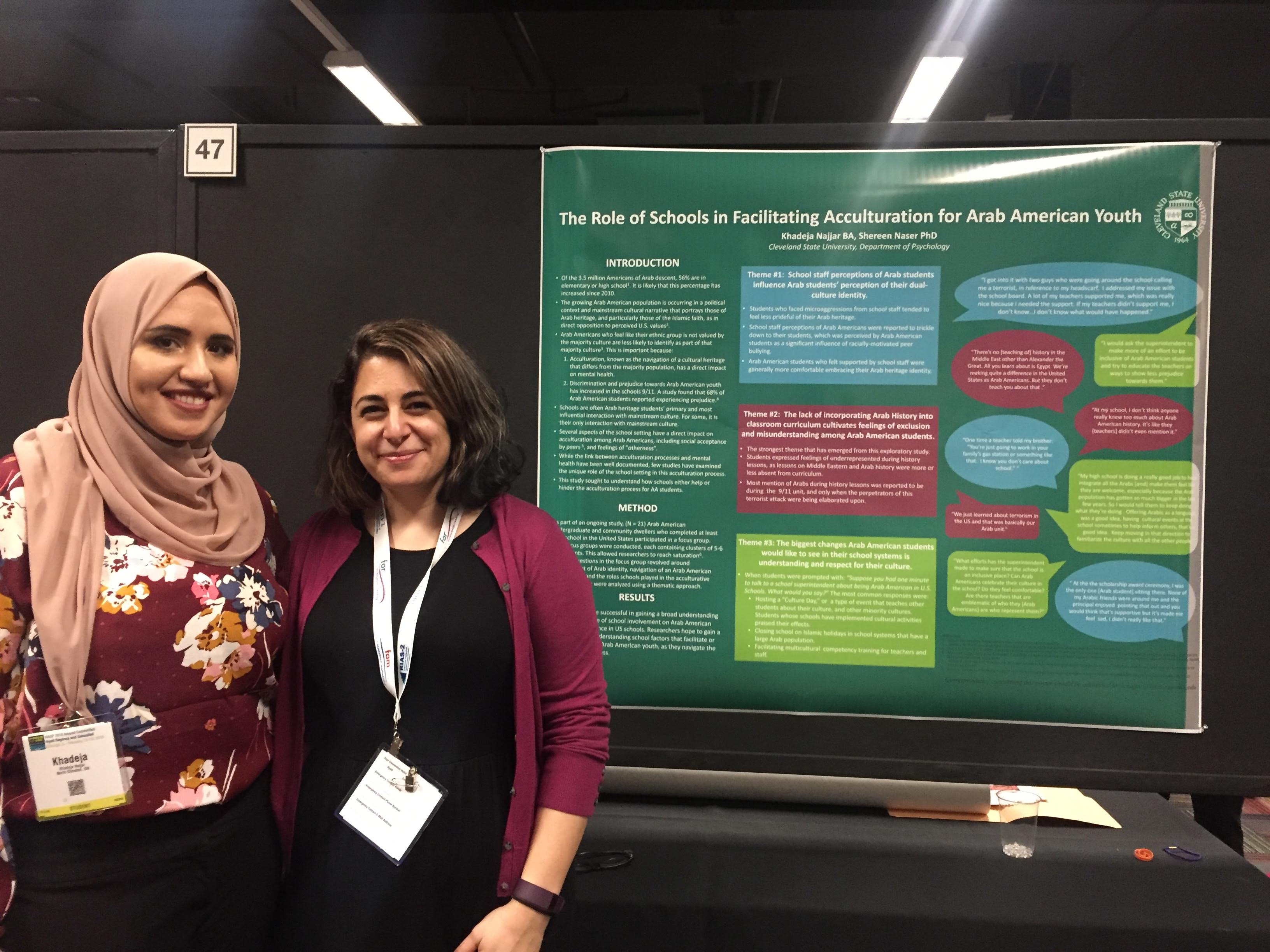 Khadeja Najjar and Dr. Shereen Naser stand by their research poster on The Role of Schools in Facilitating Acculturation for Arab American Youth